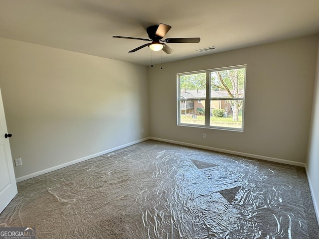 spare room featuring visible vents, baseboards, and ceiling fan