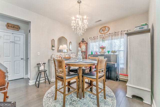 11 Bush Arbor Pl SW, Rome, GA 30165 - dining area with a chandelier, wood-type flooring, visible vents, and baseboards