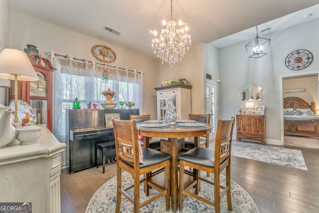 11 Bush Arbor Pl SW, Rome, GA 30165 - dining space with baseboards, an inviting chandelier, a high ceiling, visible vents, and wood-type flooring