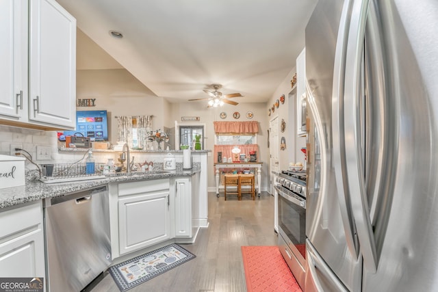 11 Bush Arbor Pl SW, Rome, GA 30165 - kitchen featuring white cabinets, a sink, ceiling fan, appliances with stainless steel finishes, and a peninsula