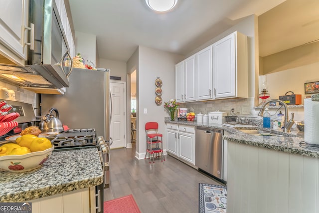11 Bush Arbor Pl SW, Rome, GA 30165 - kitchen featuring white cabinets, a sink, appliances with stainless steel finishes, dark wood-style floors, and decorative backsplash