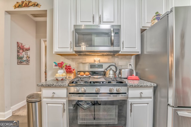 11 Bush Arbor Pl SW, Rome, GA 30165 - kitchen with white cabinetry, visible vents, appliances with stainless steel finishes, decorative backsplash, and baseboards