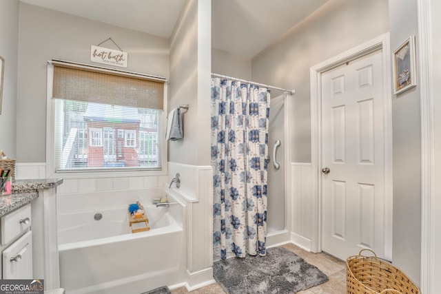 11 Bush Arbor Pl SW, Rome, GA 30165 - full bathroom with a wainscoted wall, a shower with shower curtain, tile patterned flooring, and a garden tub