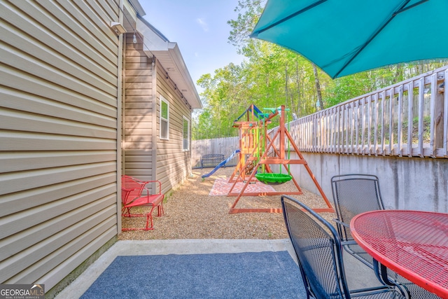 11 Bush Arbor Pl SW, Rome, GA 30165 - view of patio / terrace with fence, outdoor dining area, and a playground