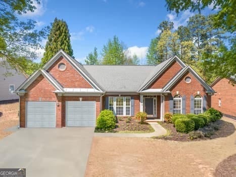 1330 Badingham Dr, Cumming, GA 30041 - view of front of property featuring driveway, an attached garage, and brick siding