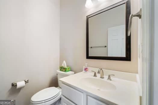 1330 Badingham Dr, Cumming, GA 30041 - half bathroom featuring toilet and vanity