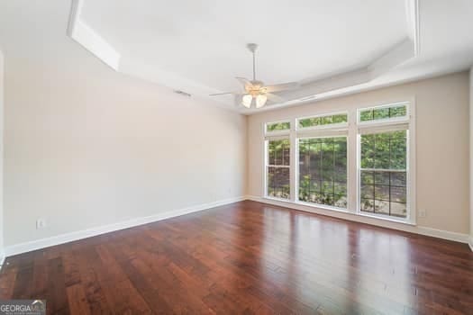 1330 Badingham Dr, Cumming, GA 30041 - empty room featuring ceiling fan and wood finished floors