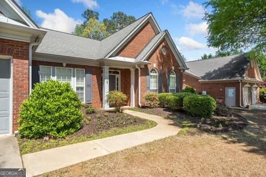 1330 Badingham Dr, Cumming, GA 30041 - view of front of house with brick siding and a garage