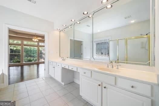 1330 Badingham Dr, Cumming, GA 30041 - full bath with tile patterned floors, double vanity, recessed lighting, and a shower with shower door