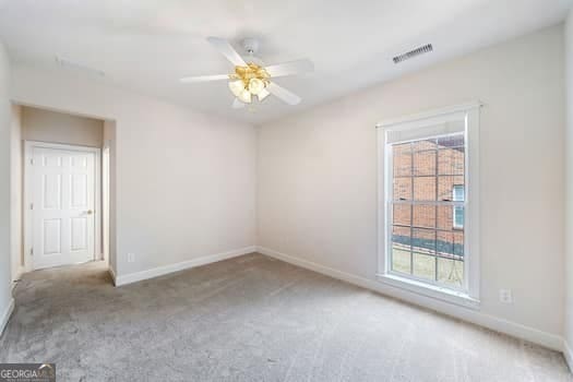 1330 Badingham Dr, Cumming, GA 30041 - carpeted spare room with plenty of natural light and ceiling fan