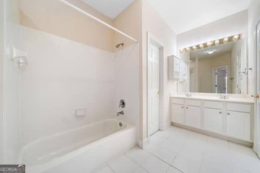 1330 Badingham Dr, Cumming, GA 30041 - bathroom with shower / bathtub combination, double vanity, and tile patterned floors