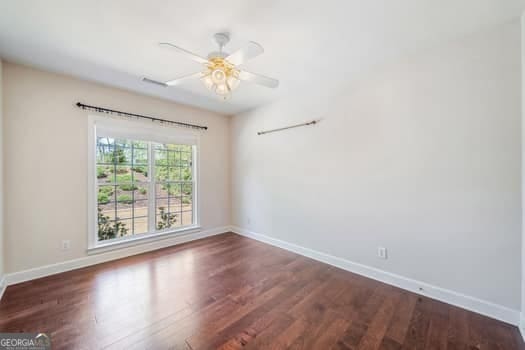 1330 Badingham Dr, Cumming, GA 30041 - spare room with wood finished floors and a ceiling fan