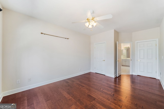 1330 Badingham Dr, Cumming, GA 30041 - unfurnished bedroom featuring dark wood-style flooring, ensuite bath, and a ceiling fan