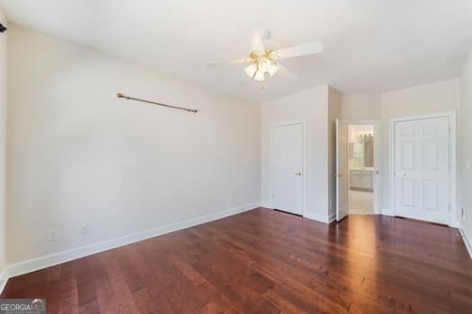 1330 Badingham Dr, Cumming, GA 30041 - unfurnished bedroom with wood finished floors, ensuite bath, and ceiling fan