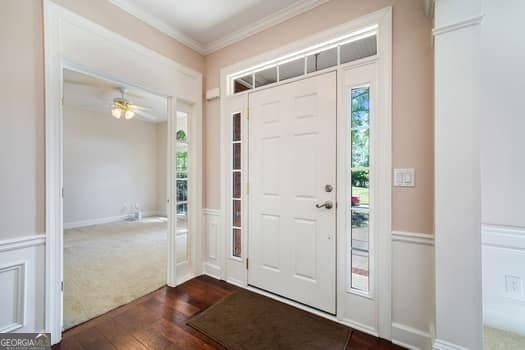1330 Badingham Dr, Cumming, GA 30041 - foyer entrance with dark wood-type flooring, crown molding, and a ceiling fan