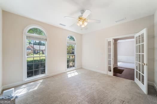 1330 Badingham Dr, Cumming, GA 30041 - carpeted empty room featuring french doors and ceiling fan