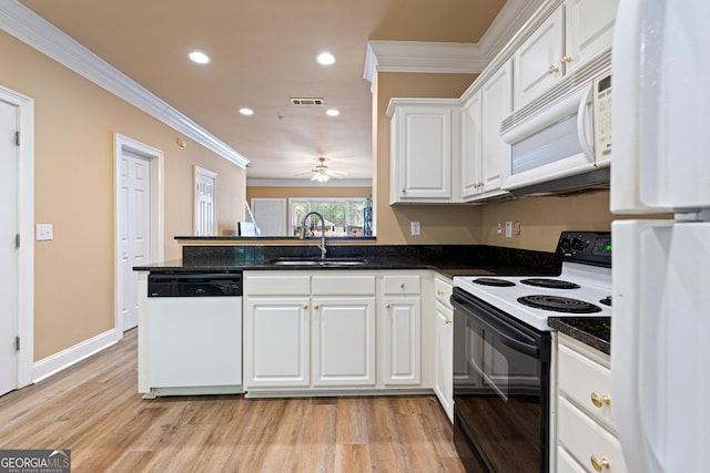 kitchen with white appliances, white cabinetry, a sink, and crown molding