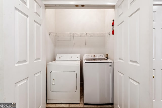 clothes washing area featuring independent washer and dryer and laundry area