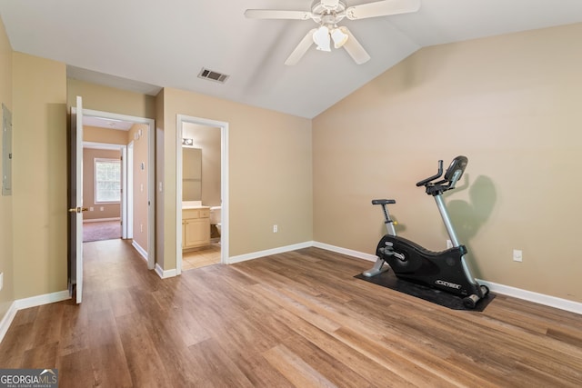 exercise room with baseboards, visible vents, ceiling fan, lofted ceiling, and wood finished floors