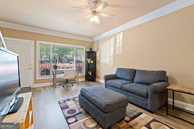living room with a ceiling fan, wood finished floors, baseboards, and ornamental molding