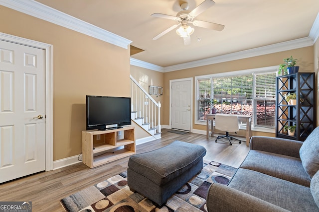 living room featuring crown molding, wood finished floors, and stairs
