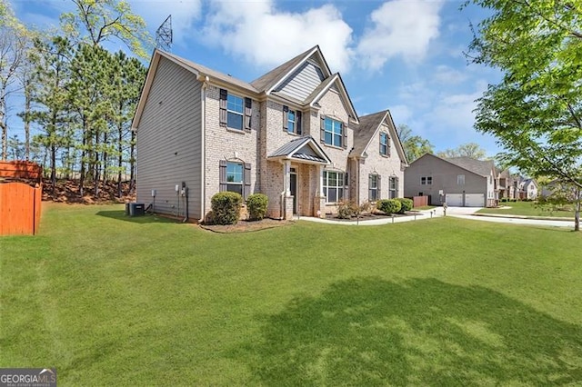 craftsman inspired home with an attached garage, driveway, a front lawn, and brick siding