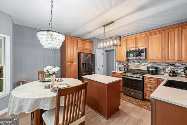 1035 Bridle Path Dr, Lawrenceville, GA 30045 - kitchen with appliances with stainless steel finishes, light countertops, decorative backsplash, and a kitchen island