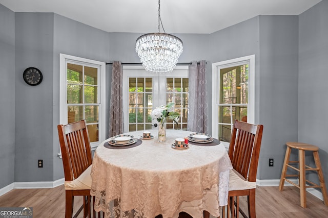 1035 Bridle Path Dr, Lawrenceville, GA 30045 - dining room with wood finished floors and a chandelier