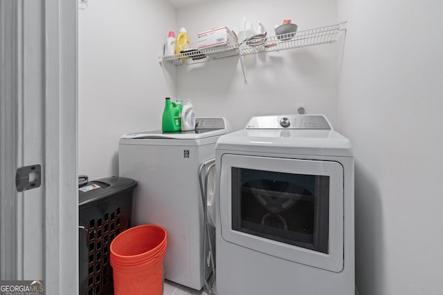 washroom with separate washer and dryer and laundry area