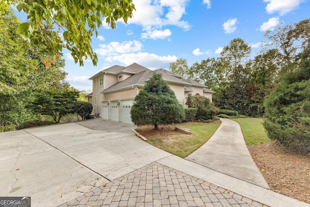 12 Arbor Shrs, Newnan, GA 30265 - view of front of home with stucco siding, concrete driveway, a front lawn, and a garage