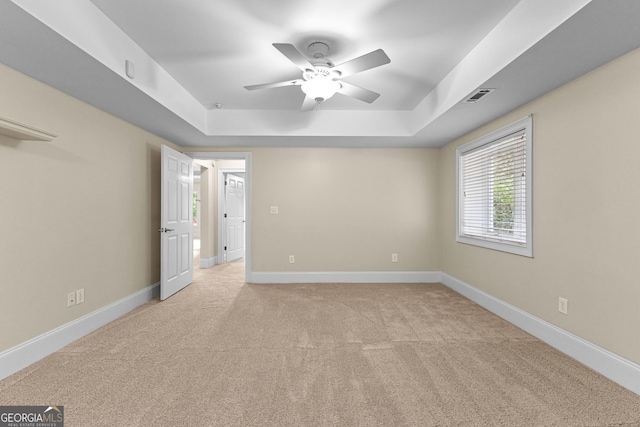 12 Arbor Shrs, Newnan, GA 30265 - unfurnished bedroom with a tray ceiling, light carpet, and ceiling fan