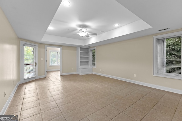 12 Arbor Shrs, Newnan, GA 30265 - empty room featuring a raised ceiling, light tile patterned floors, built in features, a ceiling fan, and recessed lighting