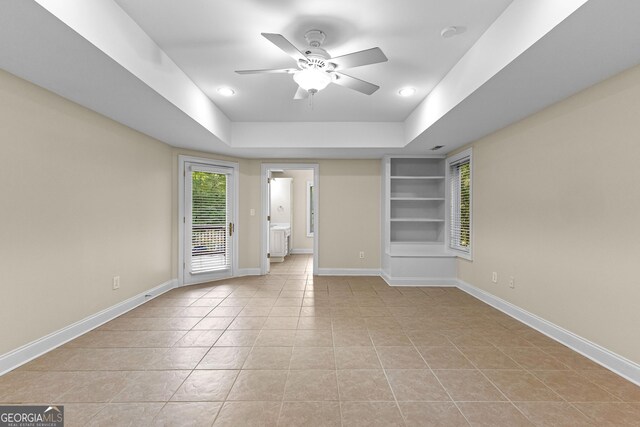 12 Arbor Shrs, Newnan, GA 30265 - spare room with a ceiling fan, light tile patterned flooring, built in shelves, recessed lighting, and a tray ceiling