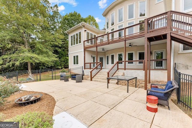 12 Arbor Shrs, Newnan, GA 30265 - rear view of house featuring a fire pit, a ceiling fan, a patio area, stucco siding, and a wooden deck