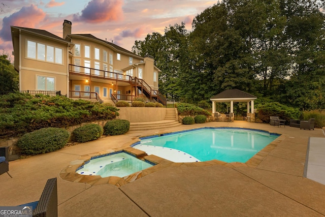 12 Arbor Shrs, Newnan, GA 30265 - pool at dusk with a gazebo, stairs, a patio, and a pool with connected hot tub