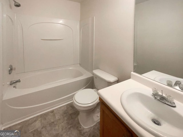 bathroom featuring toilet, vanity, and shower / bathtub combination
