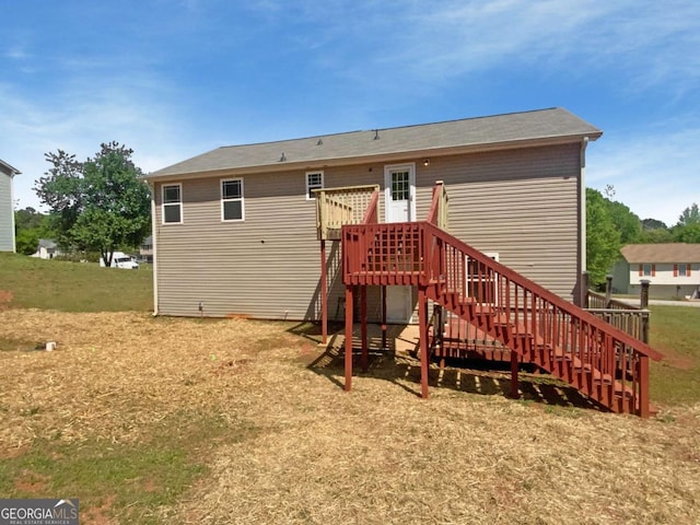 back of house featuring stairway and a wooden deck
