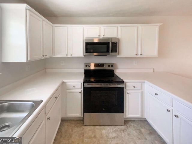 kitchen featuring white cabinetry, light countertops, and appliances with stainless steel finishes
