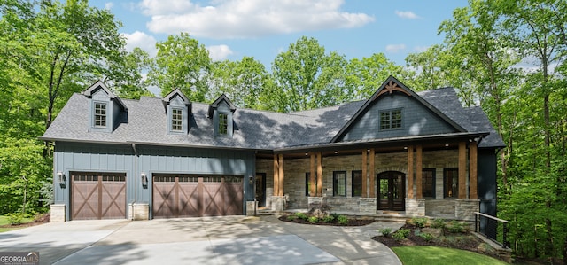 448 Golden Bear Pass, Dahlonega, GA 30533 - view of front facade with covered porch, concrete driveway, stone siding, a garage, and a shingled roof