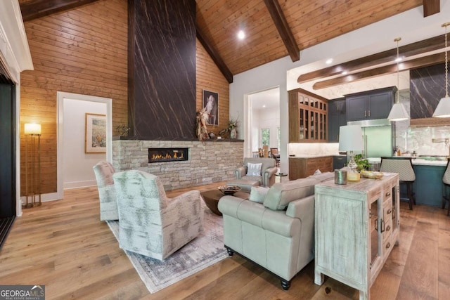 448 Golden Bear Pass, Dahlonega, GA 30533 - living room featuring high vaulted ceiling, a stone fireplace, wood finished floors, wooden walls, and wood ceiling with exposed beams