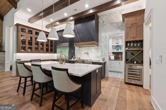 448 Golden Bear Pass, Dahlonega, GA 30533 - kitchen with appliances with stainless steel finishes, beverage cooler, tasteful backsplash, light wood-type flooring, and beamed ceiling