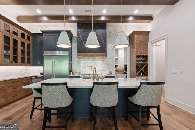 448 Golden Bear Pass, Dahlonega, GA 30533 - kitchen with built in refrigerator, backsplash, beamed ceiling, glass insert cabinets, and an island with sink
