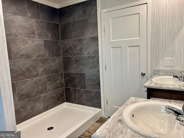bathroom featuring a shower stall, vanity, and wood finished floors