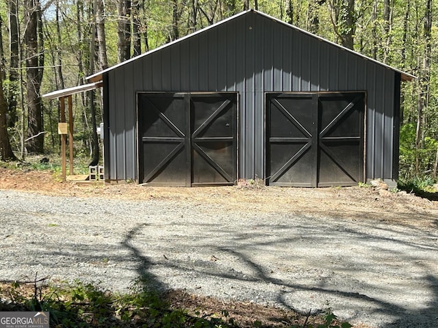 view of outbuilding featuring an outdoor structure and a wooded view