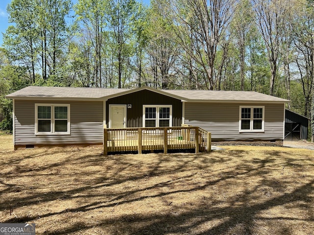 manufactured / mobile home with a wooden deck, crawl space, and a shingled roof