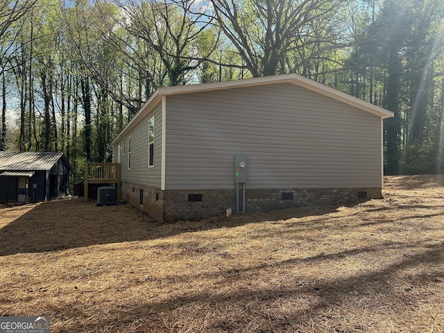 view of side of property featuring crawl space and cooling unit
