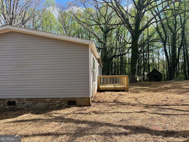 view of property exterior with a wooden deck and crawl space