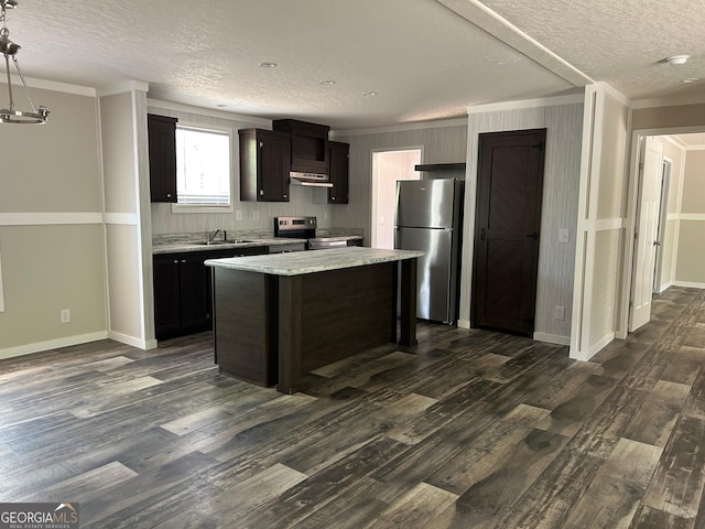 kitchen featuring under cabinet range hood, crown molding, appliances with stainless steel finishes, and a textured ceiling