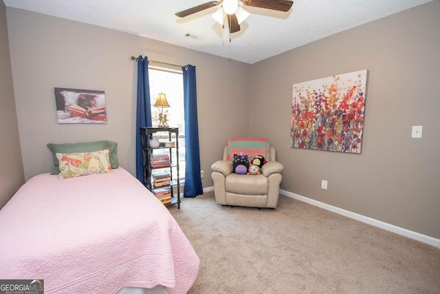 carpeted bedroom featuring visible vents, baseboards, and ceiling fan