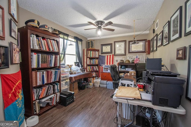 office area featuring a ceiling fan, wood finished floors, a textured ceiling, and visible vents